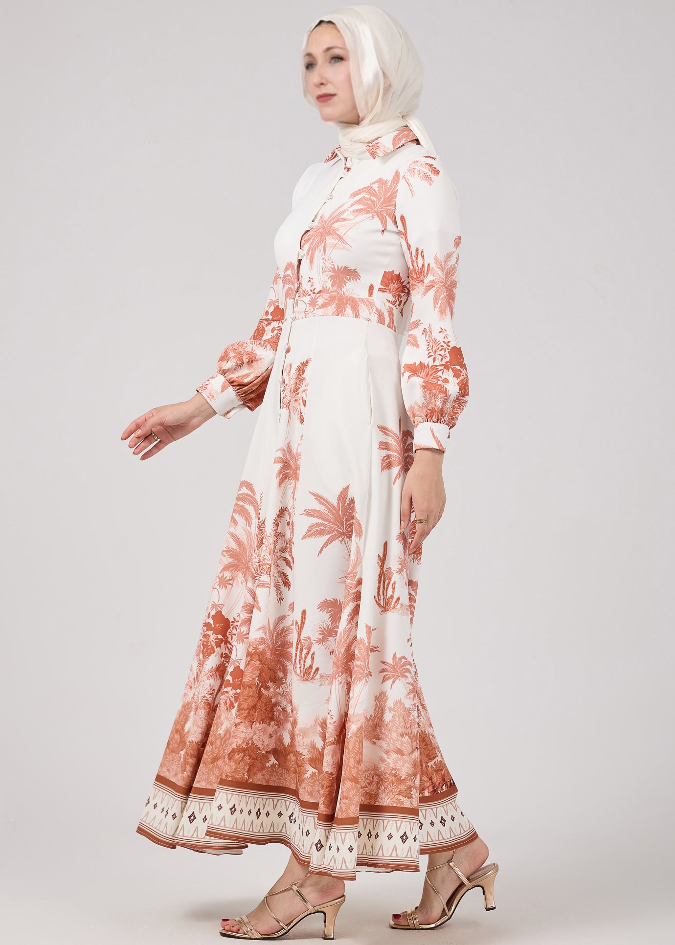 Side profile of Serafina Maxi Dress highlighting the flowing silhouette and vintage-inspired palm print