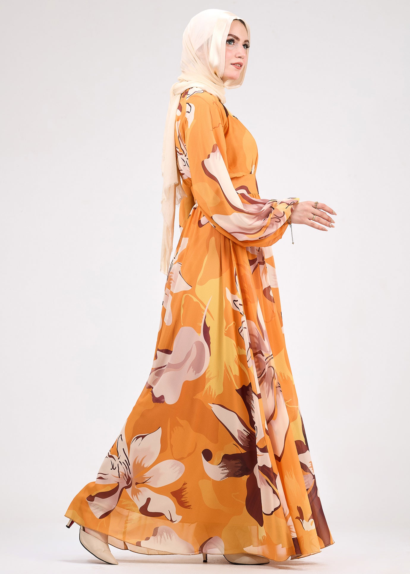 Closeup of flared sleeves on amber chiffon floral modest dress