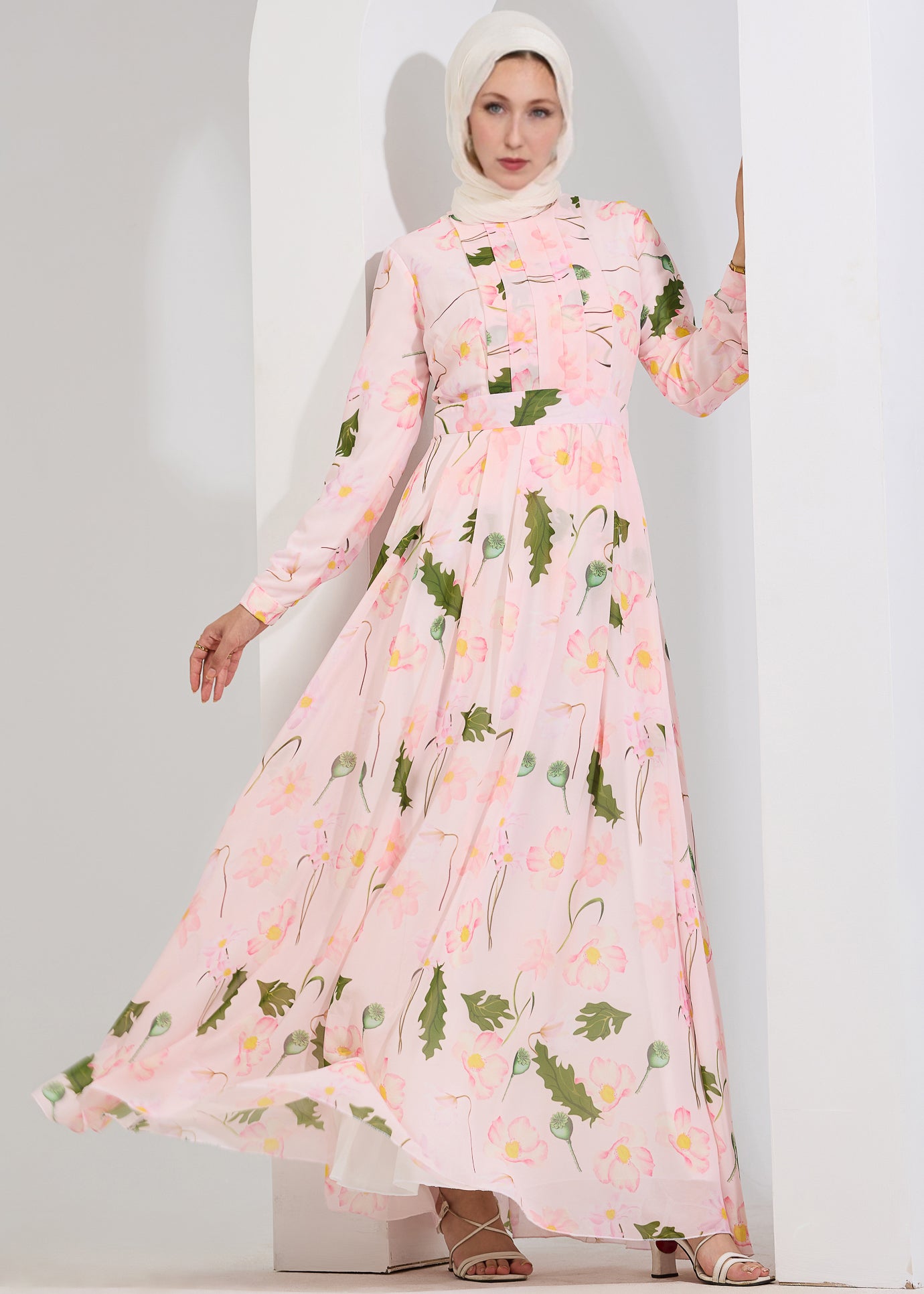 Model wearing blush floral chiffon maxi dress front view