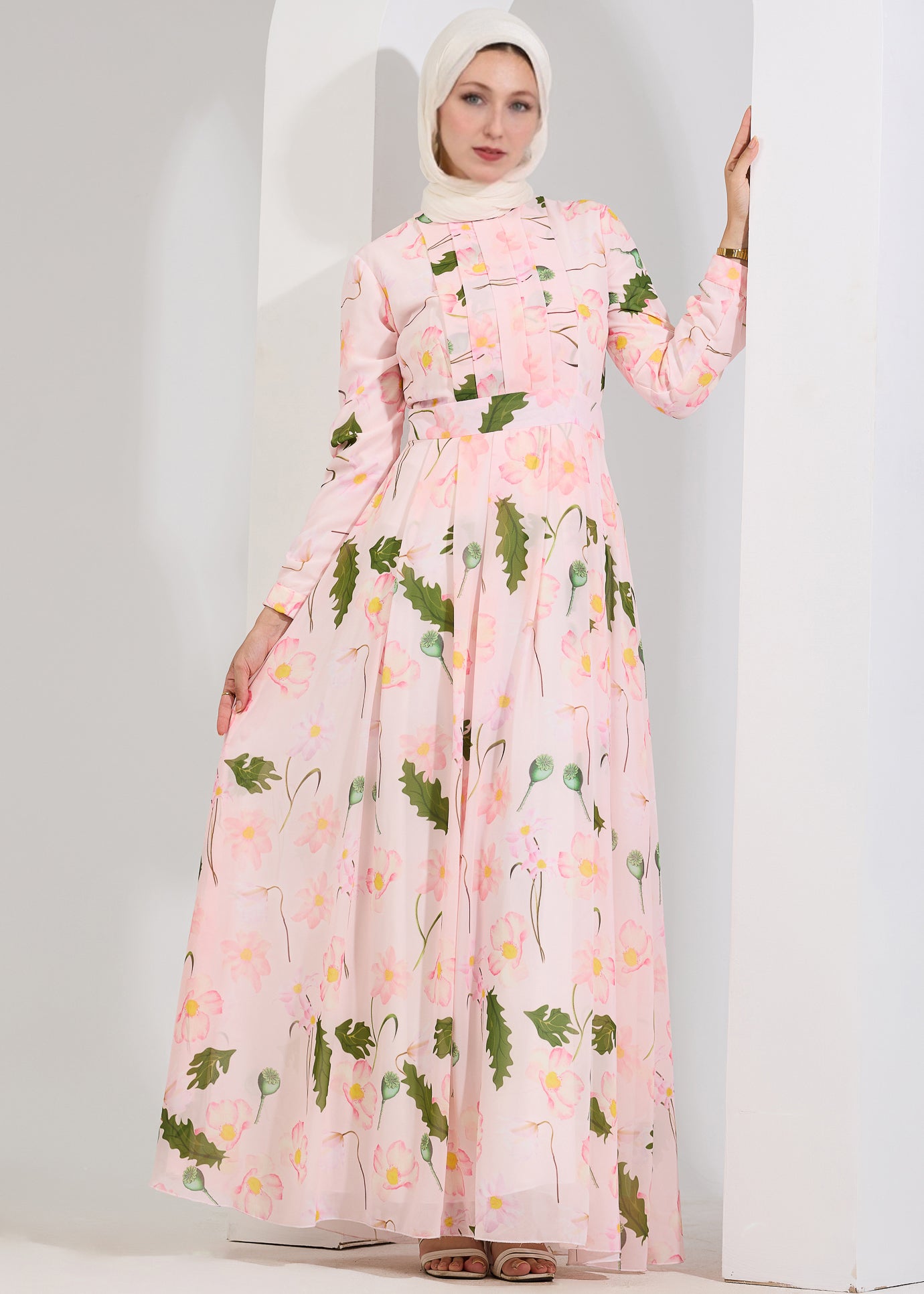 Side view of blush floral chiffon maxi dress with long sleeves