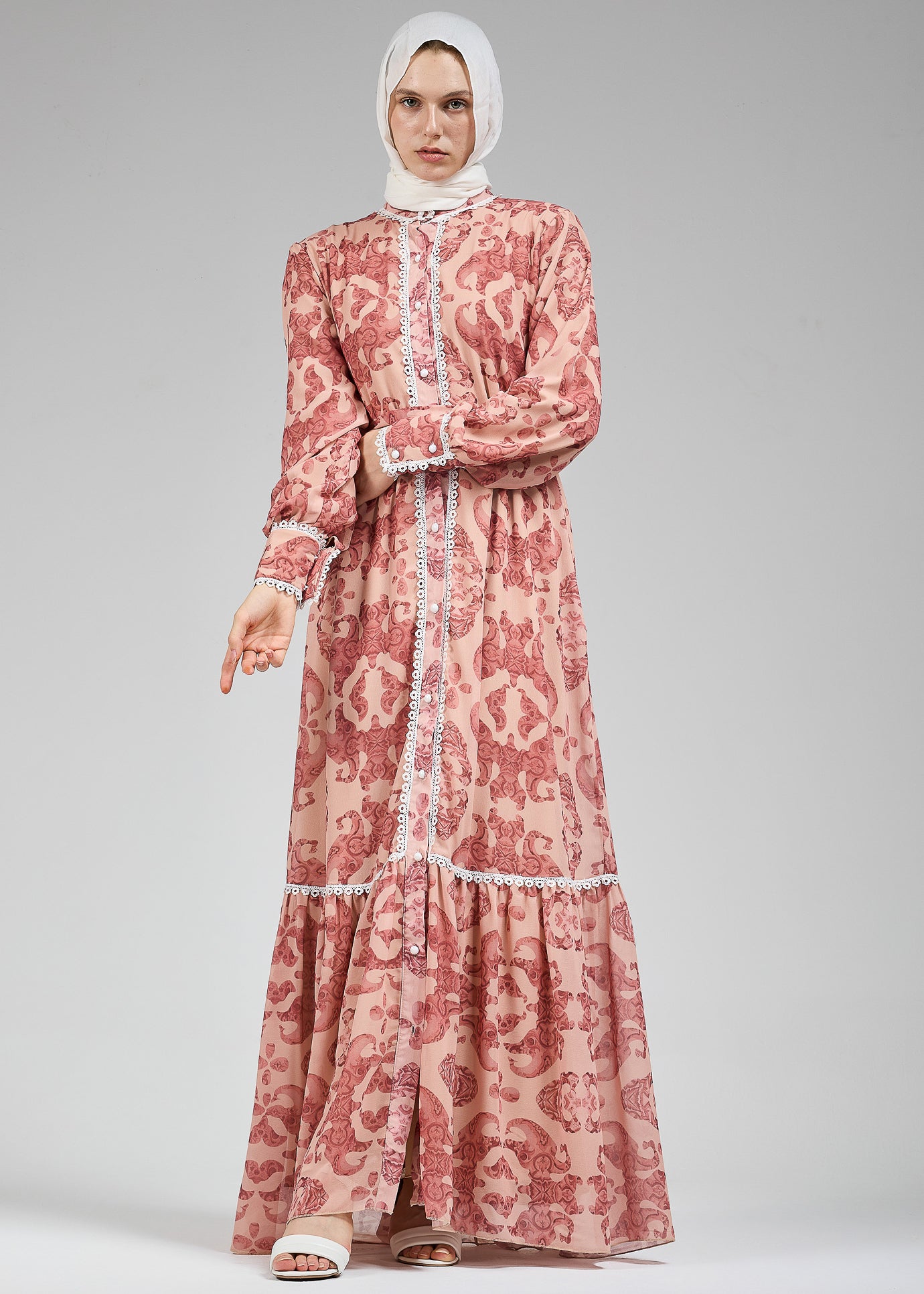 Side view of floral lace-trimmed chiffon maxi dress in blush with belt