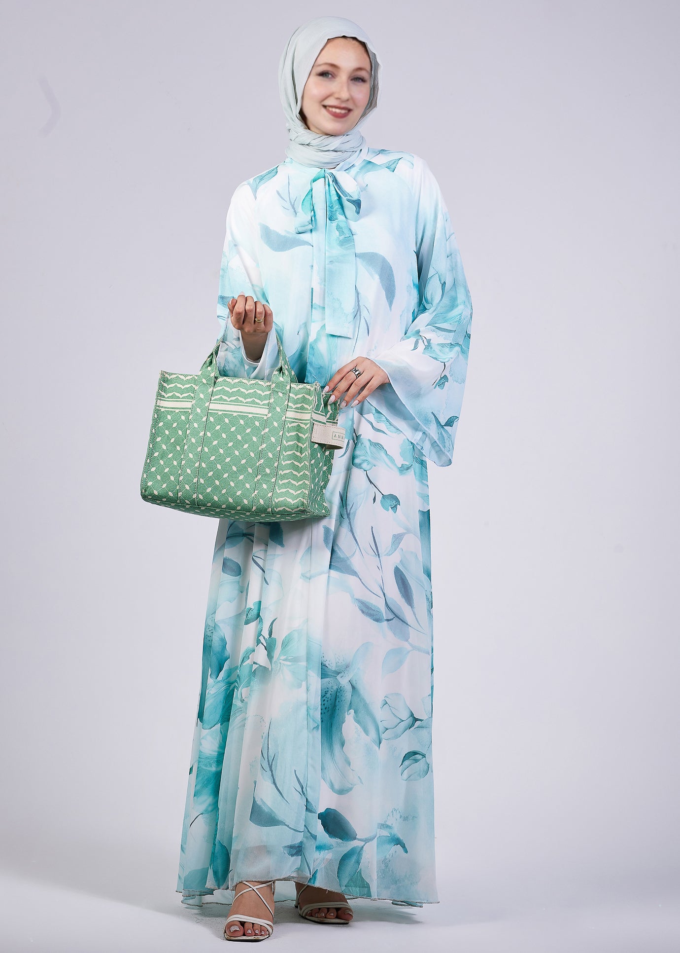 Front view of the Elegance Floral Maxi Dress showcasing the flowing sleeves and high neck