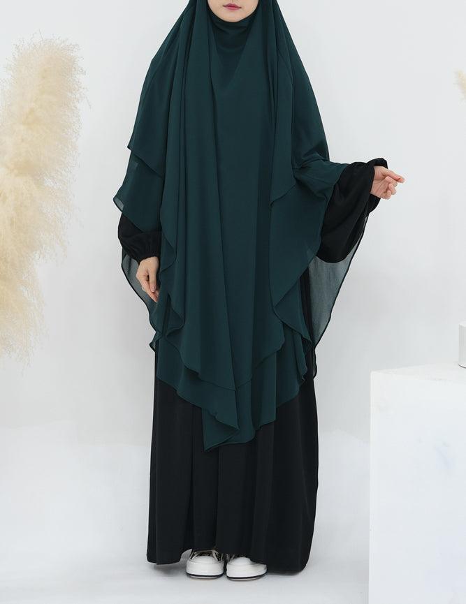 Full view of the extra-long dark green chiffon veil