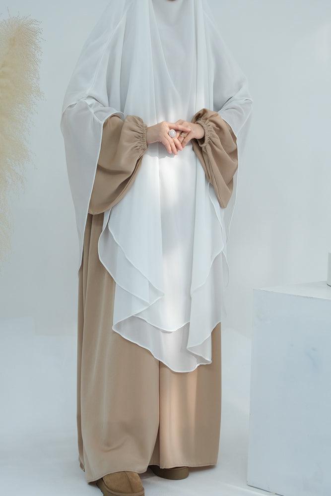 Extra long white chiffon khimar paired with a dress (dress not included).