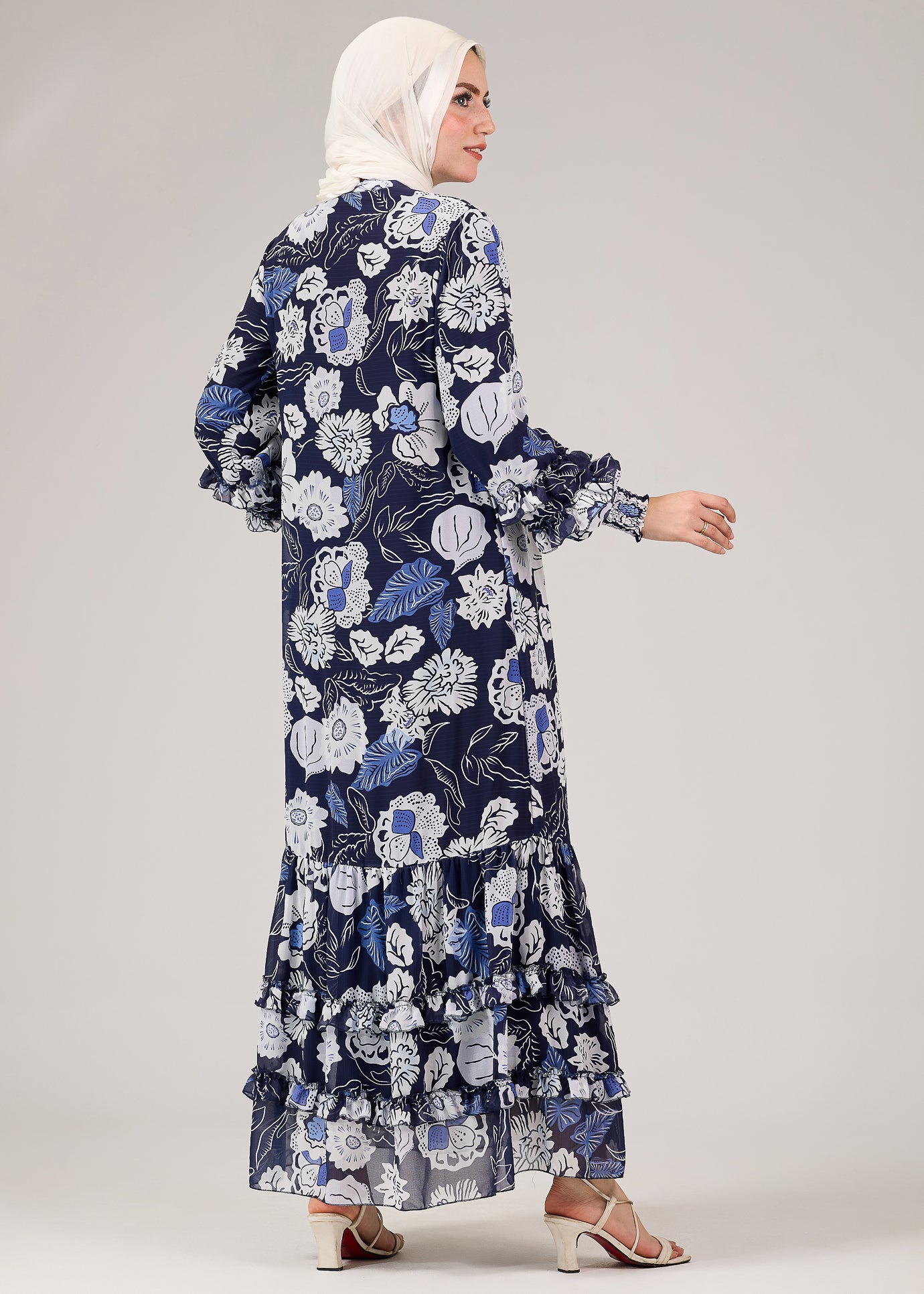 Back view of floral chiffon modest dress showcasing tiered ruffles