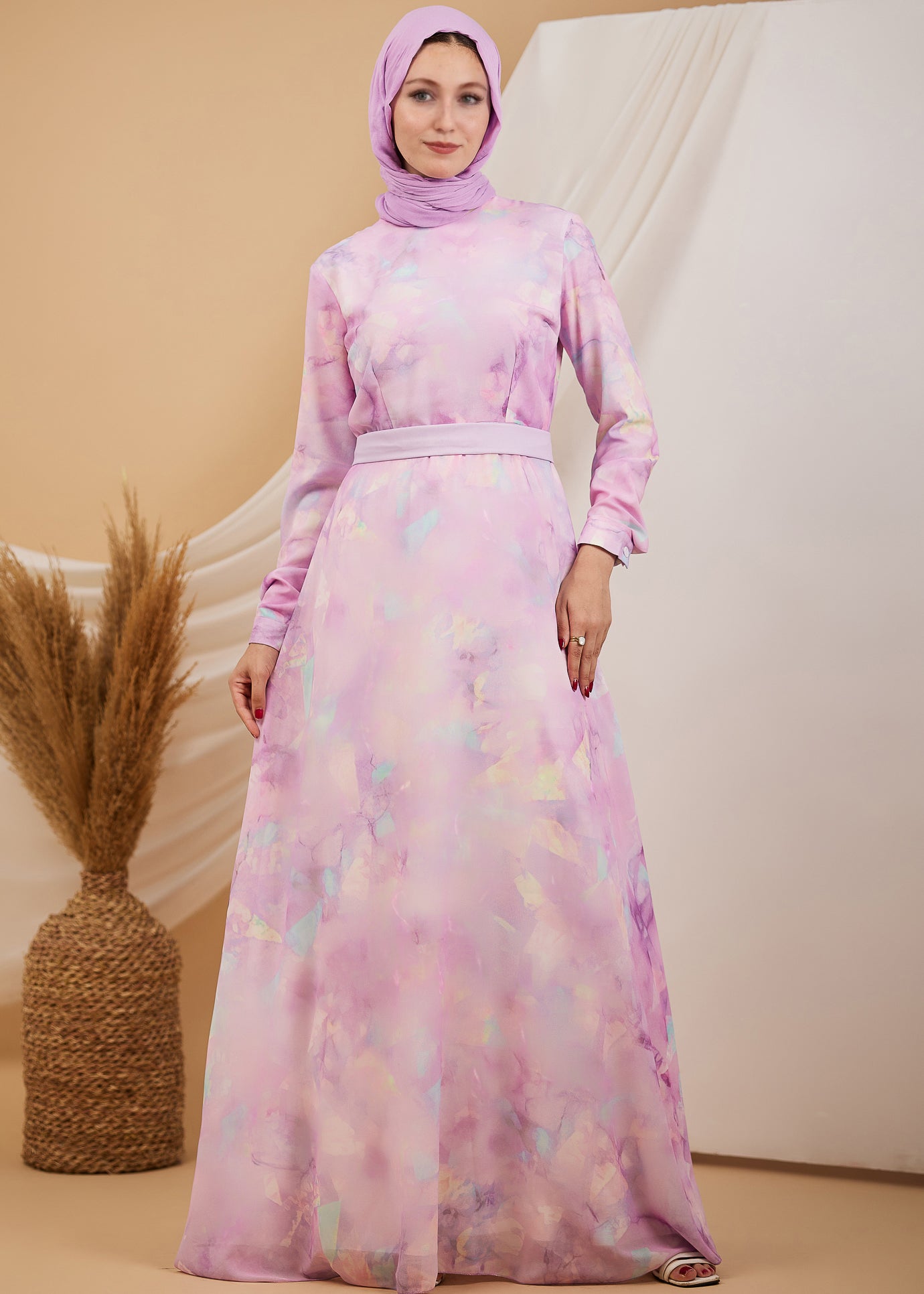 Front view of a lavender chiffon maxi dress with a high neck, worn by a woman