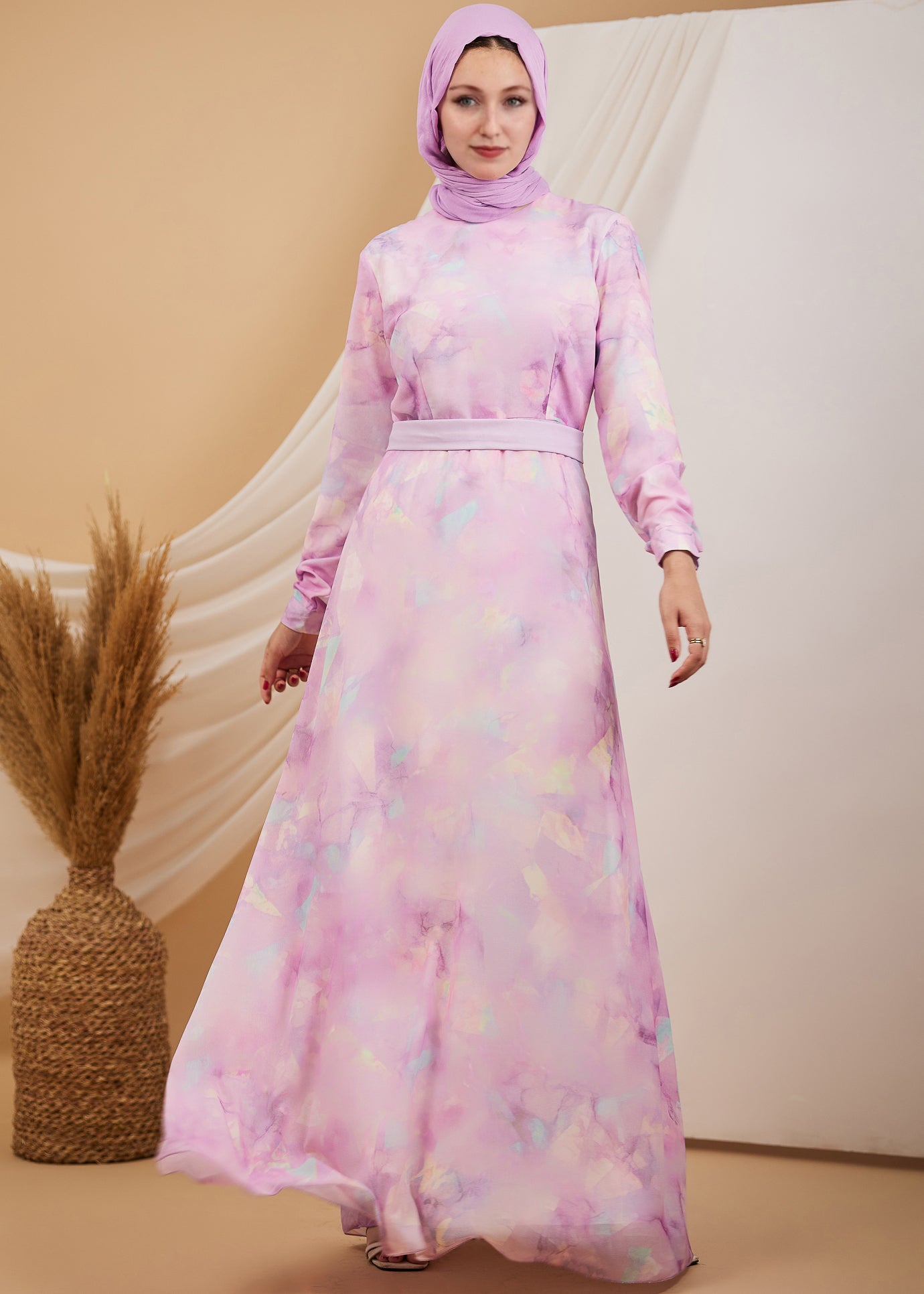 Full body shot of a woman in a lavender high neck chiffon maxi dress, showcasing the flowing design