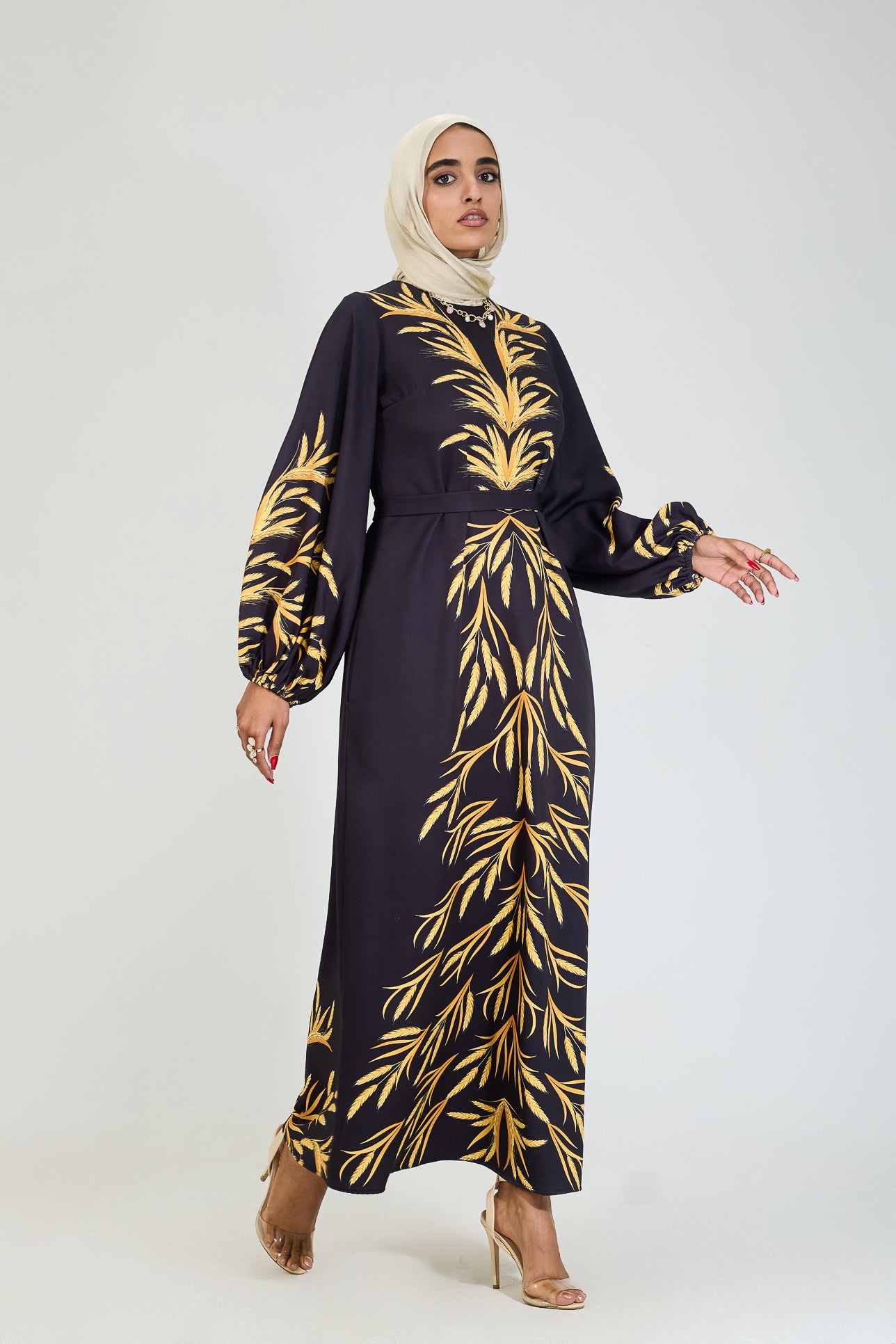 Front view of golden leaf modesty dress in black crepe.
