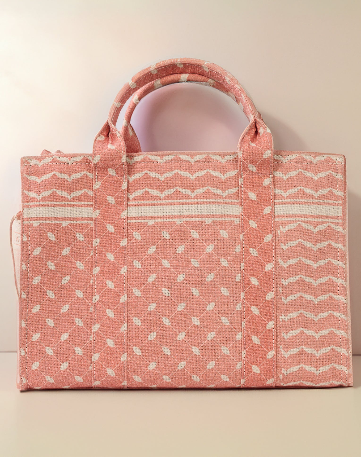 Zipper closure detail on the Heritage Coral and Cream Medium Tote