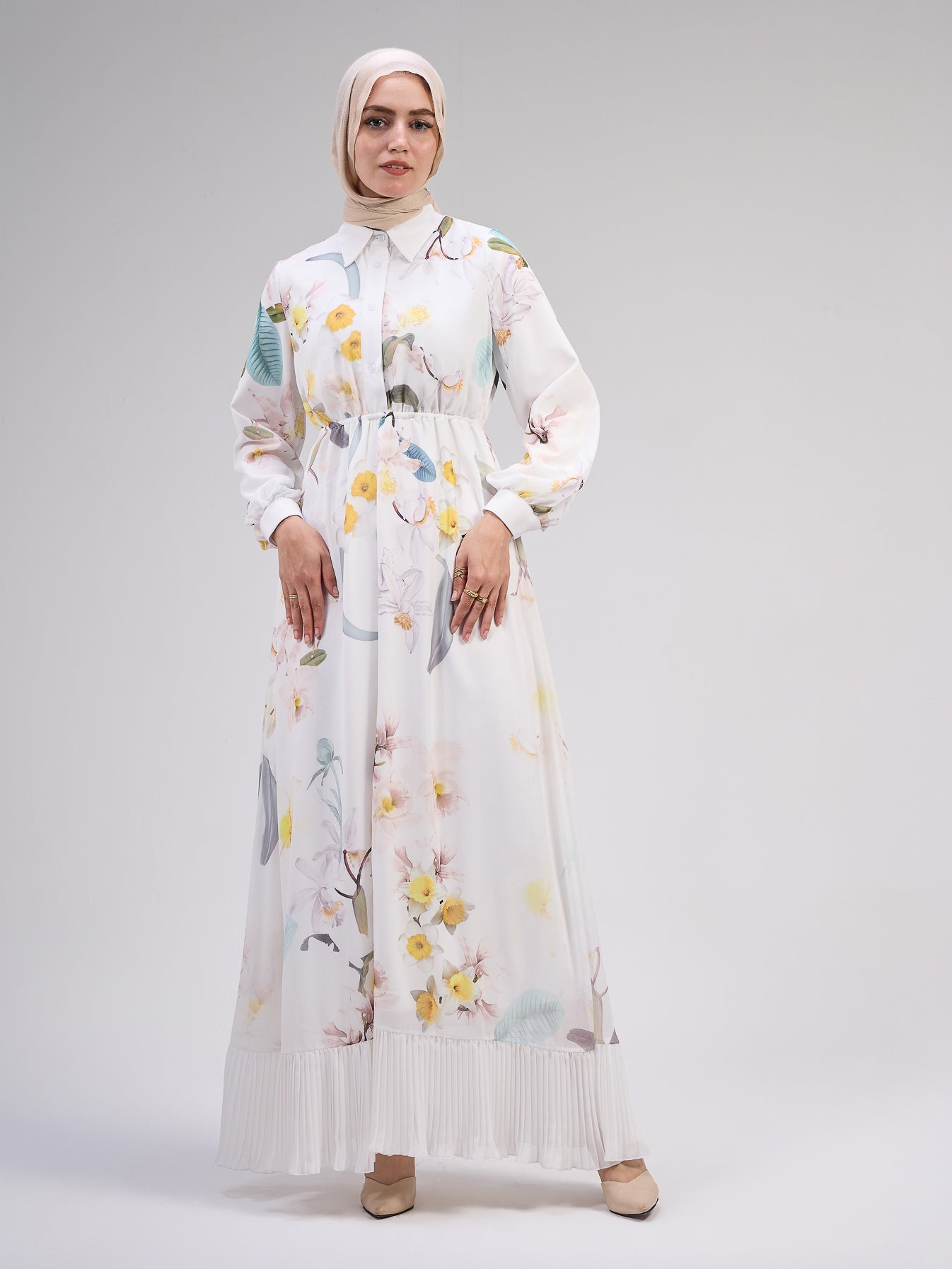 Back view of the ivory chiffon floral maxi dress with a pleated hem