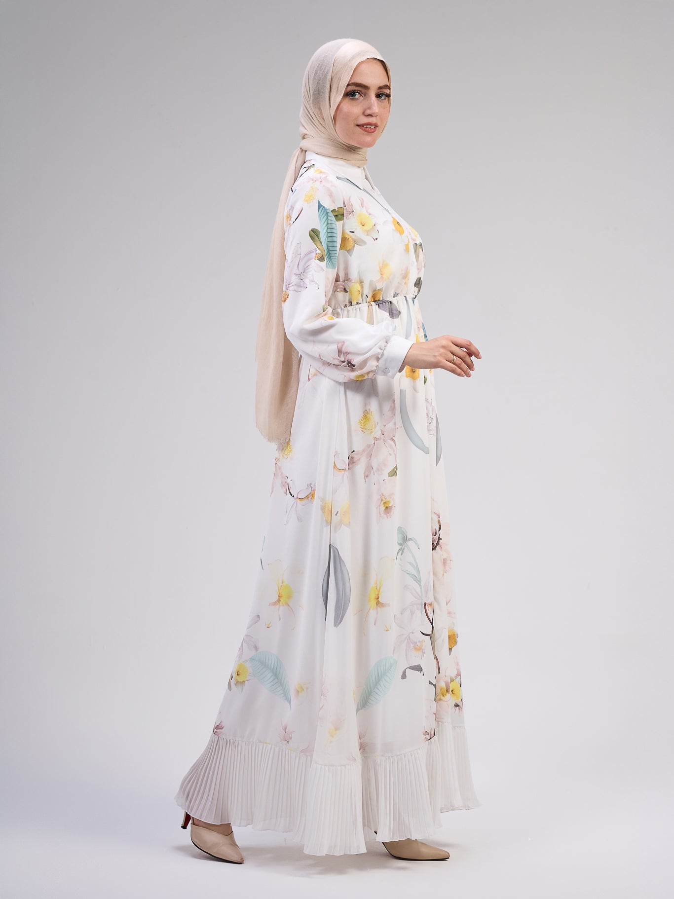 Close-up of floral patterns on the ivory chiffon dress