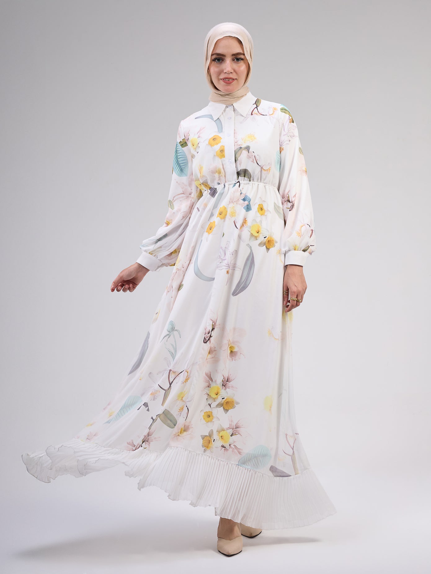 Front view of an ivory floral chiffon maxi dress with pleats