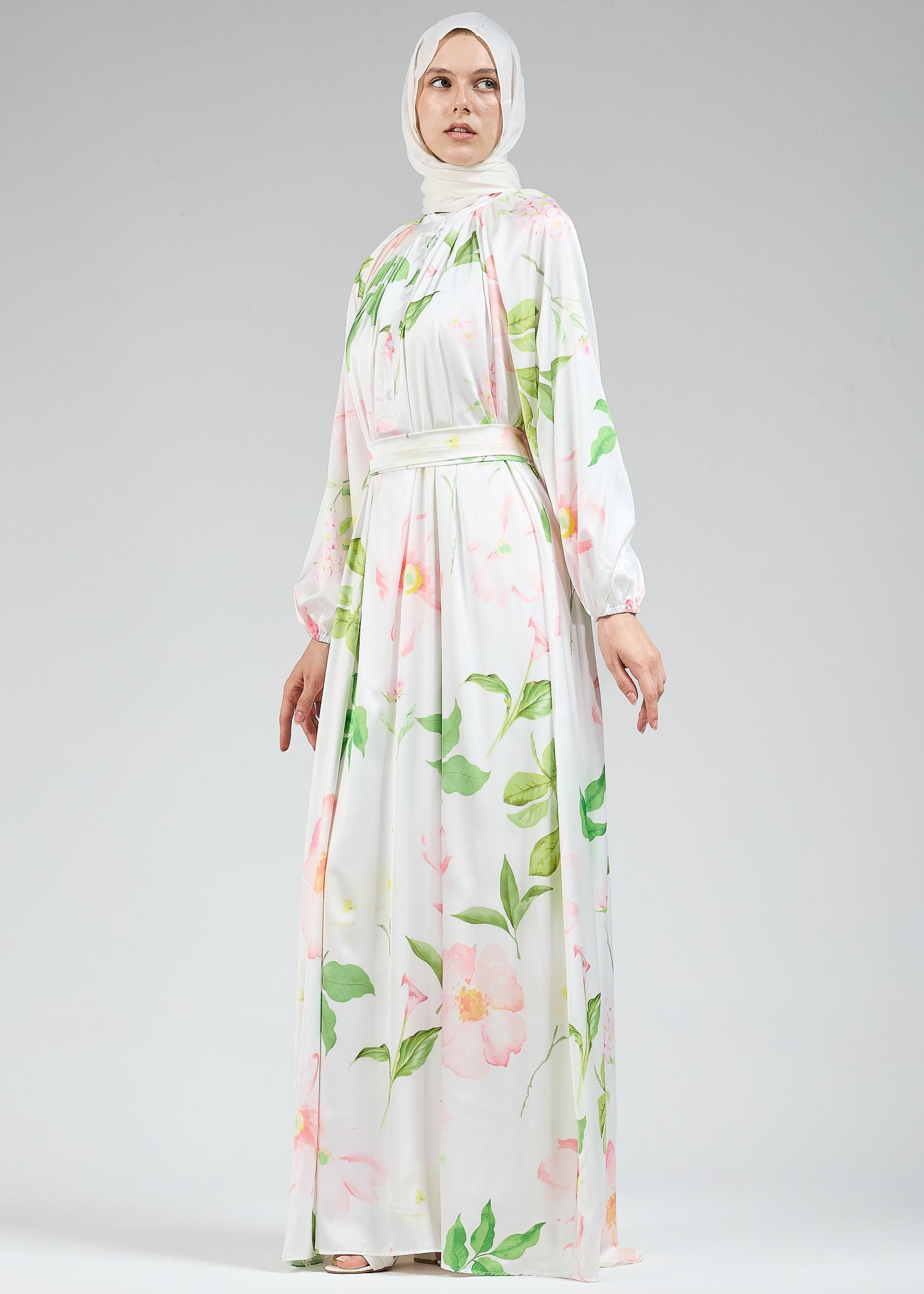 A front view of the long white satin dress with floral design