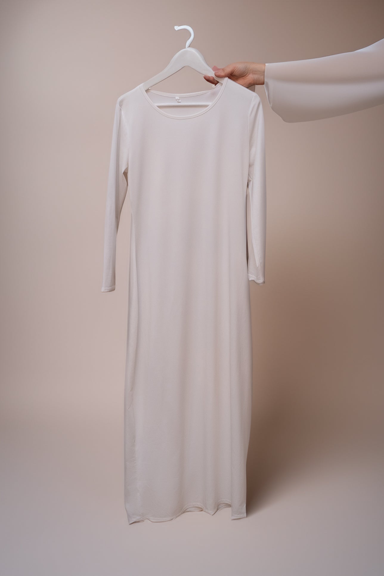 Back view of Marquis Slip Dress Maxi Length and Long Sleeve in White by Annah Hariri