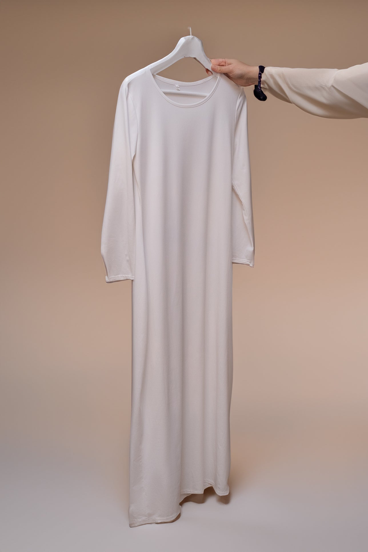 Side view of Marquis Slip Dress Maxi Length and Long Sleeve in White by Annah Hariri