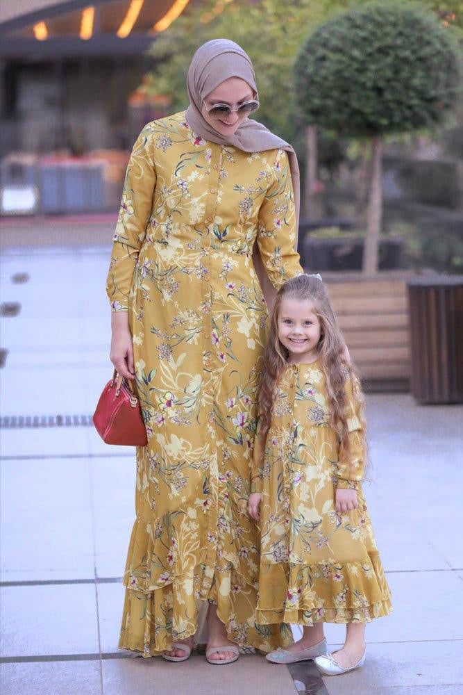 Front view of a girl wearing the Mini Amara Floral Chiffon Dress