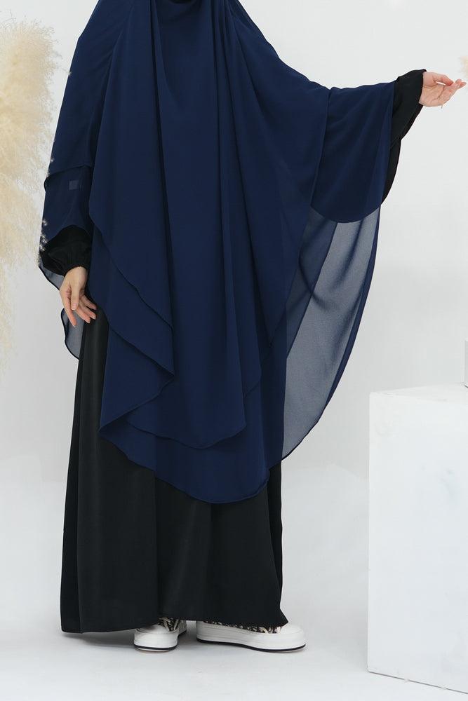 Side profile of navy chiffon accessory showing layered detail