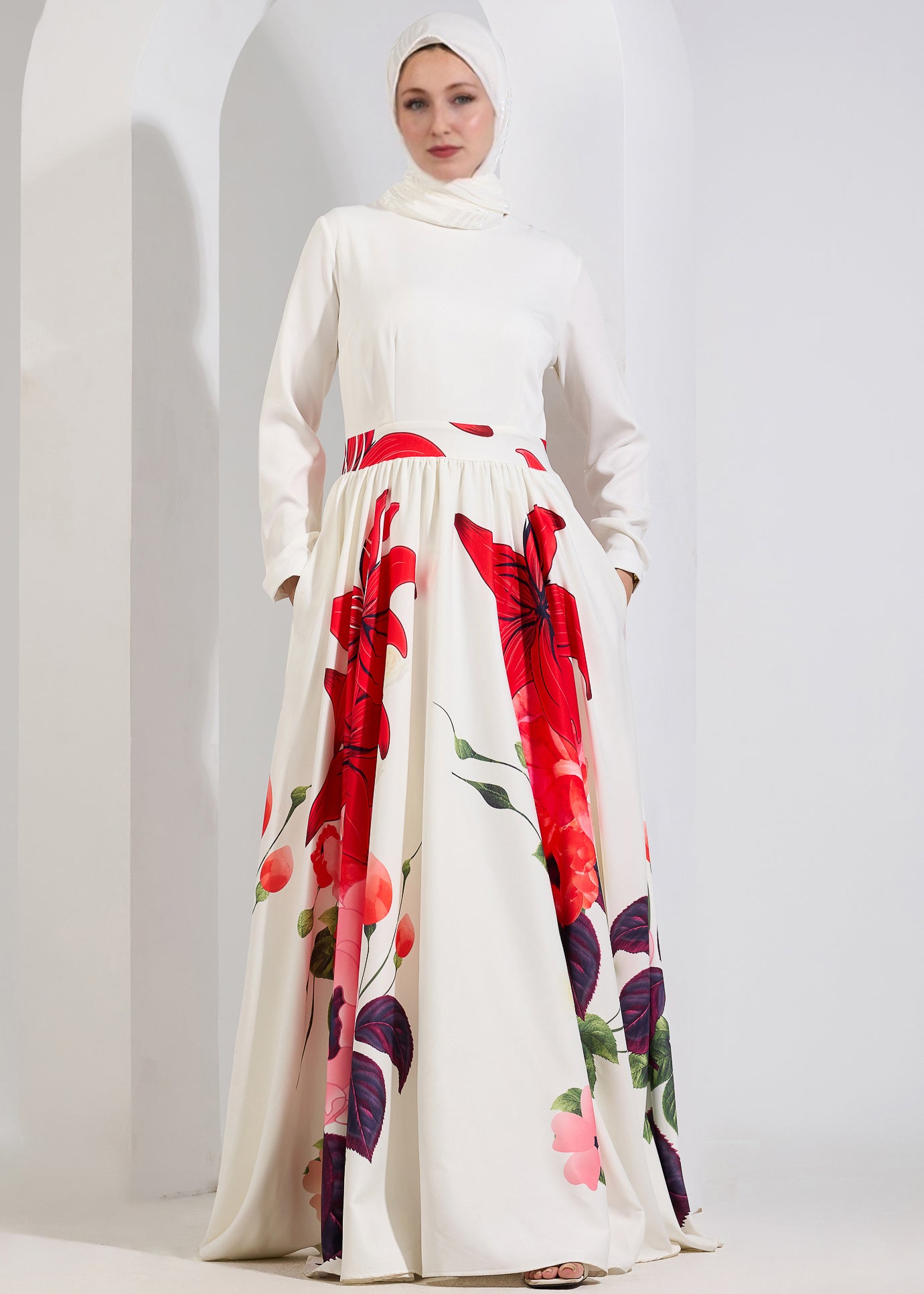 A close-up of a model in the Radiant Blossom Crepe Maxi Dress, emphasizing the high neckline and red floral print