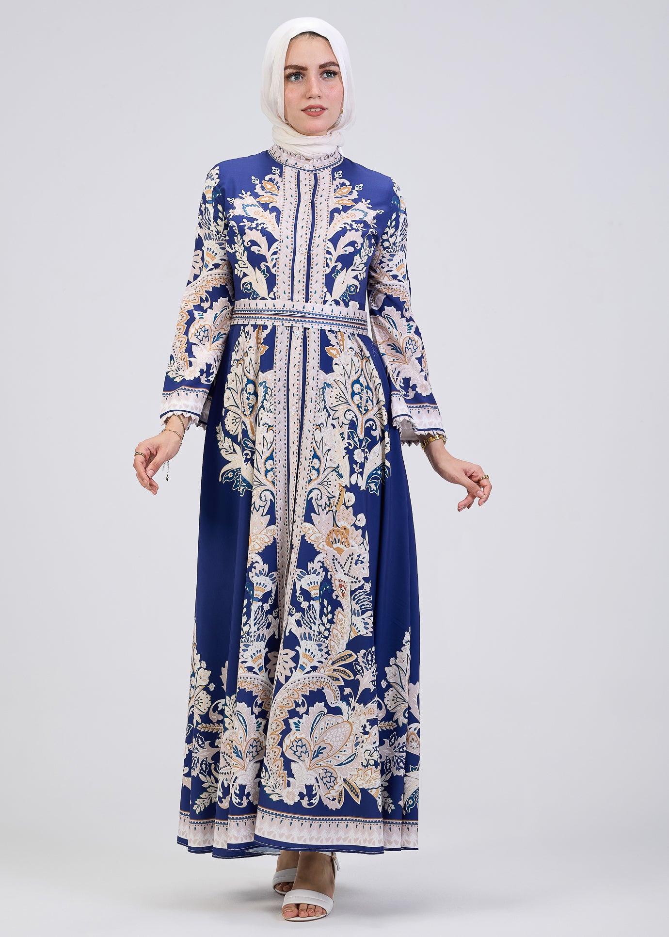 Back view of royal blue floral print modest dress with belt