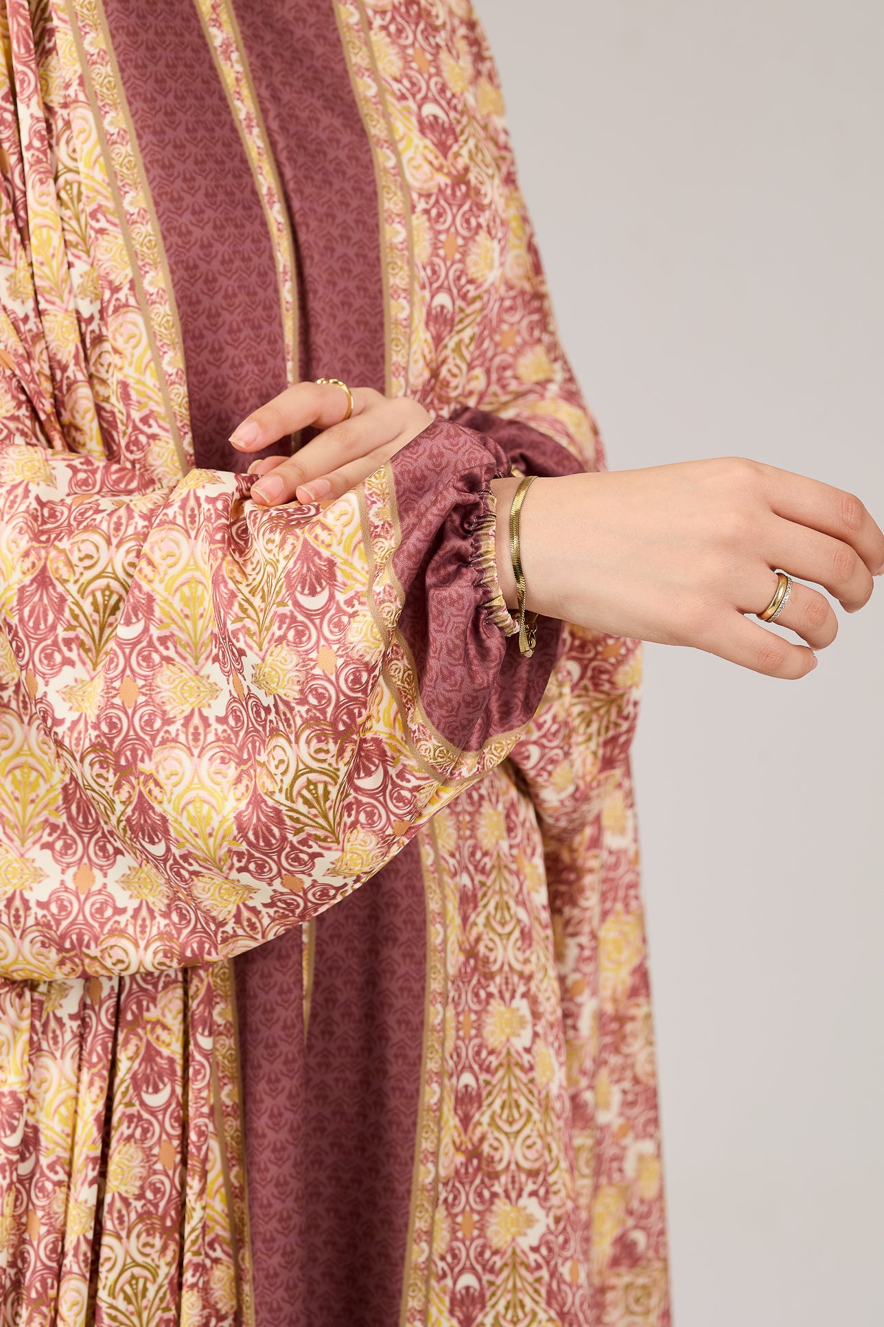 Close-up of model’s hand wearing satin floral gown