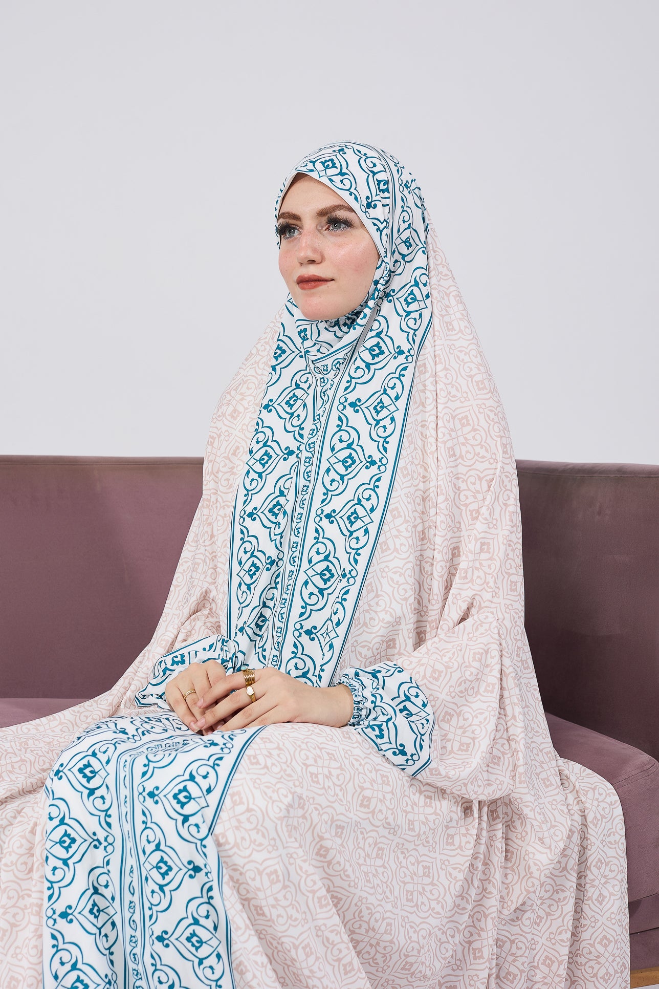 Woman seated in satin home prayer gown
