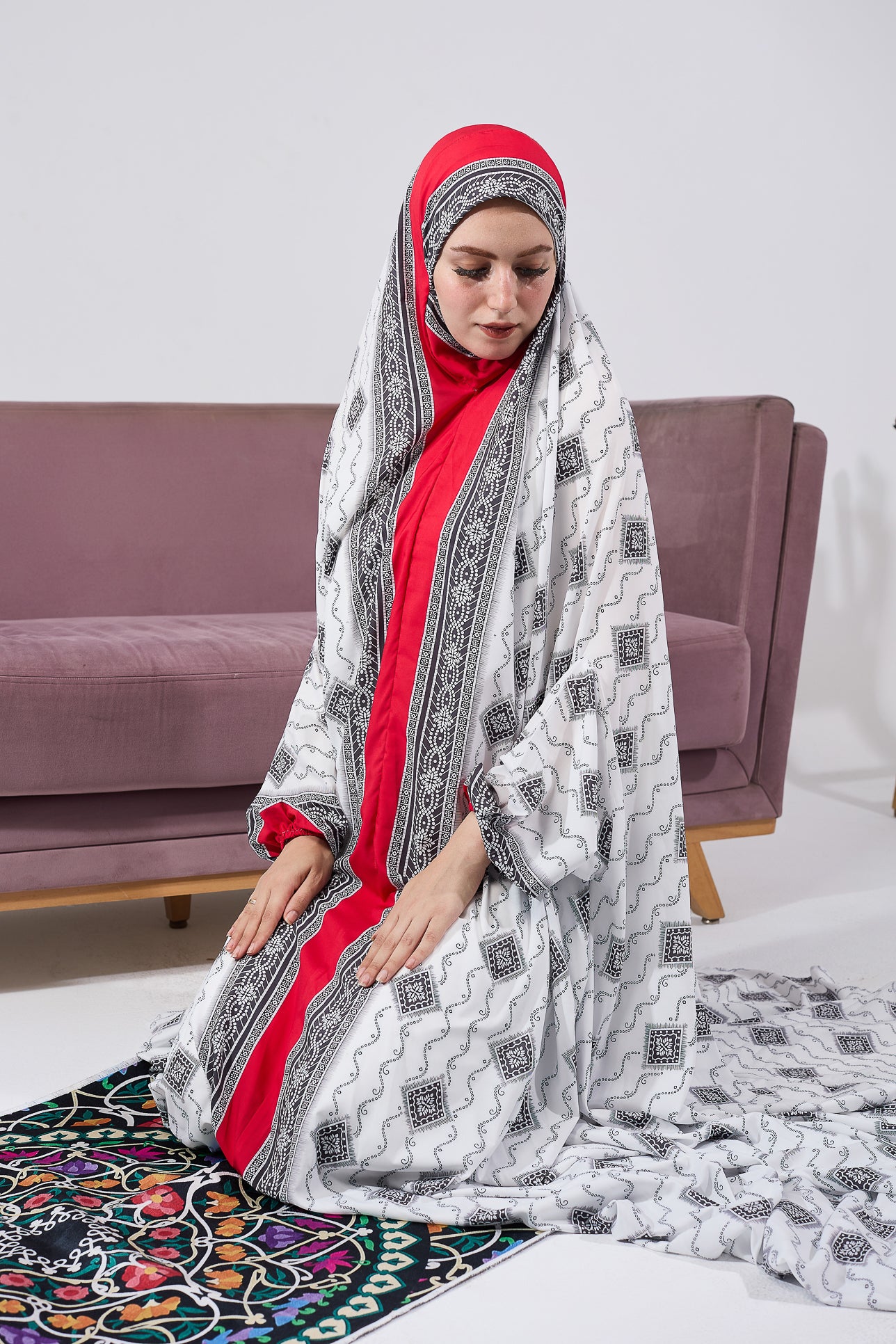 Close-up of black and white patterned satin prayer gown with red cuffs