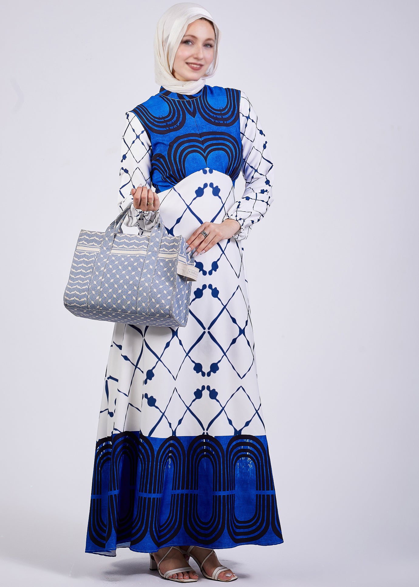 Serena Blue Geometric Print Maxi Dress - Model Holding Bag
