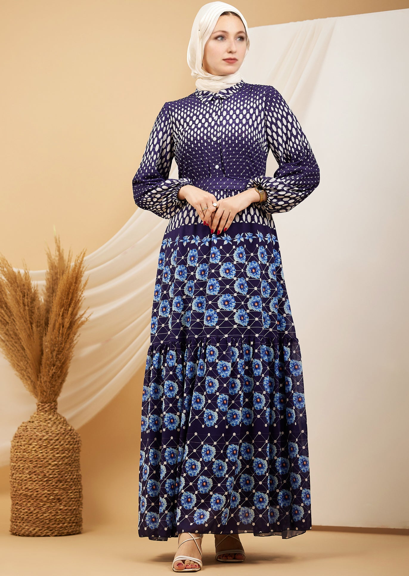 Side angle of a navy floral chiffon maxi dress showing the flowing silhouette