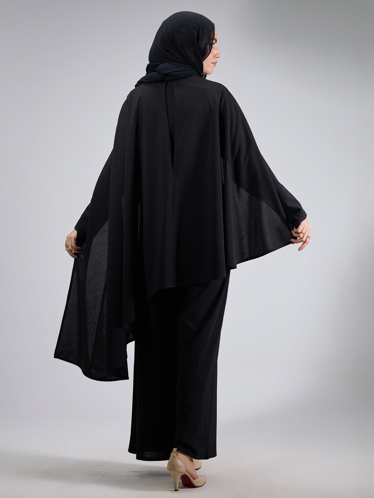 Back view highlighting the flowing cape design