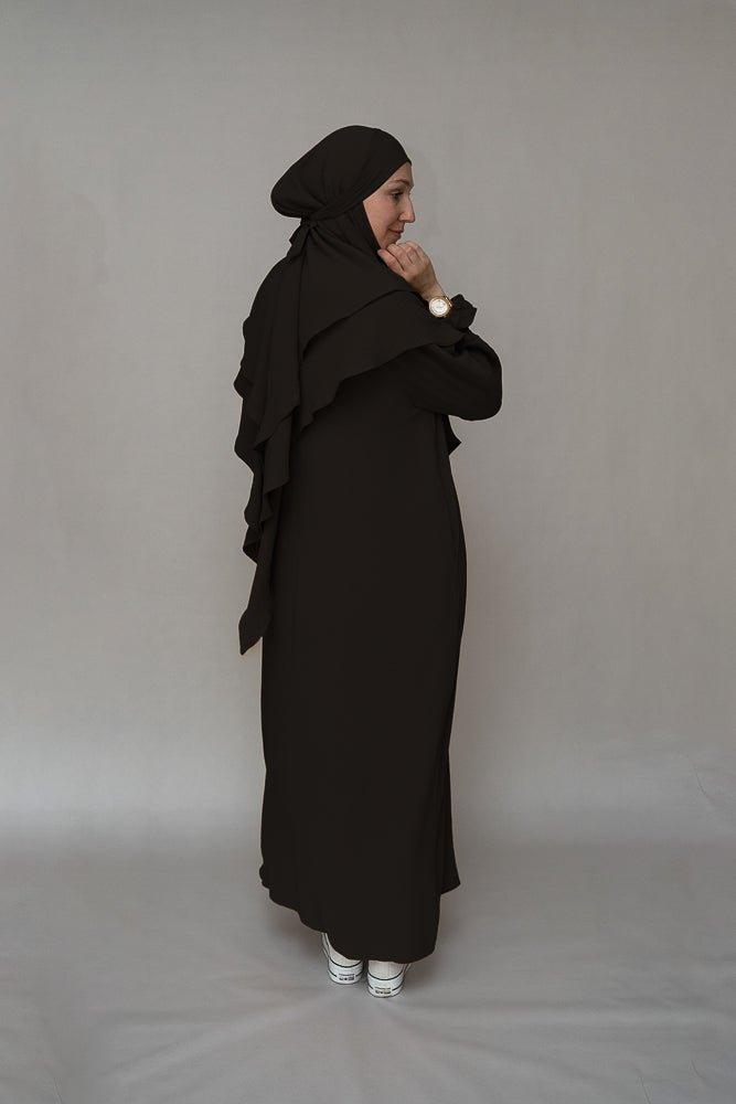 Full-length view of the black abaya dress by Annah Hariri