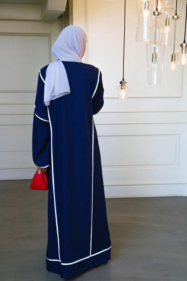 Back view of dark blue abaya with crisp white trim