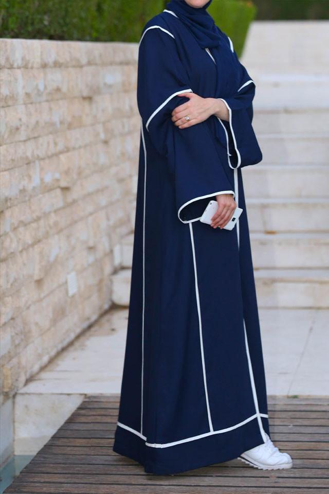 Side view of dark blue abaya showing sleeve and trim details