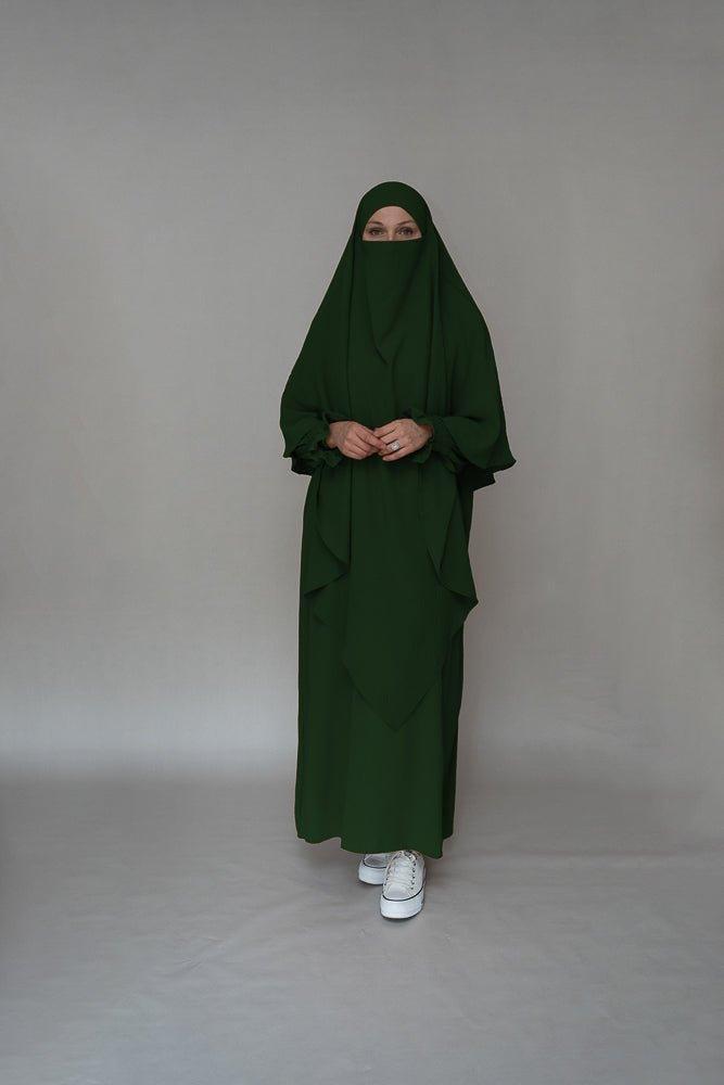 Front view of the dark green modest dress by Annah Hariri