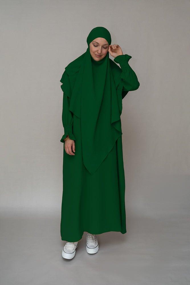 Full-length view of the dark green modest dress by Annah Hariri