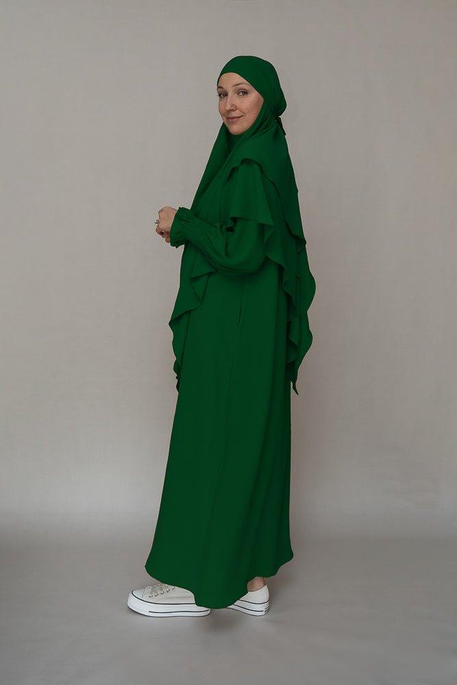 Close-up of pockets on the dark green modest dress by Annah Hariri