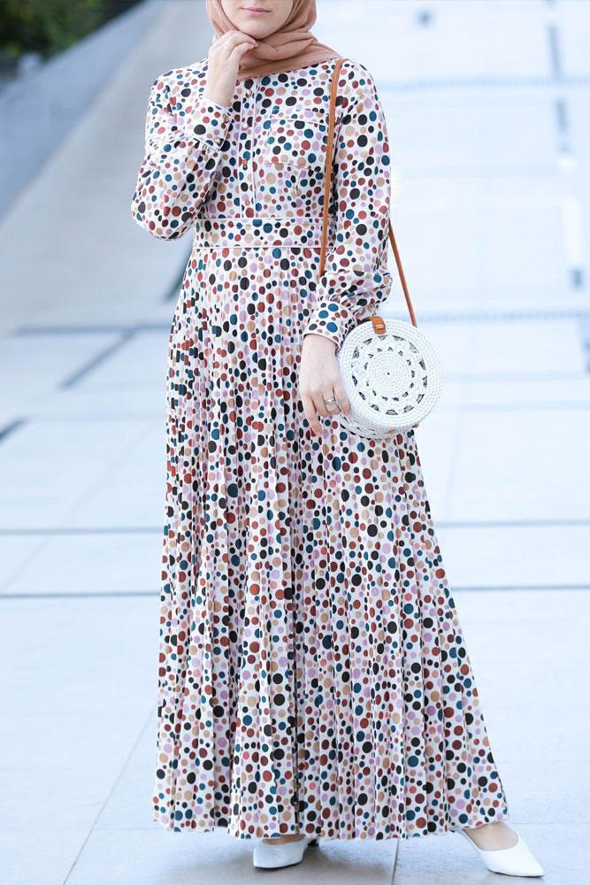 Walking shot showcasing the flow of the Dotted Delight Maxi Dress