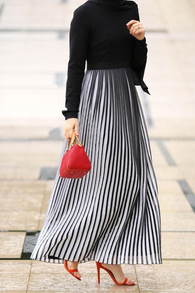 Side view showcasing the pleated skirt of the Elegant Accordion Pleats Maxi Dress