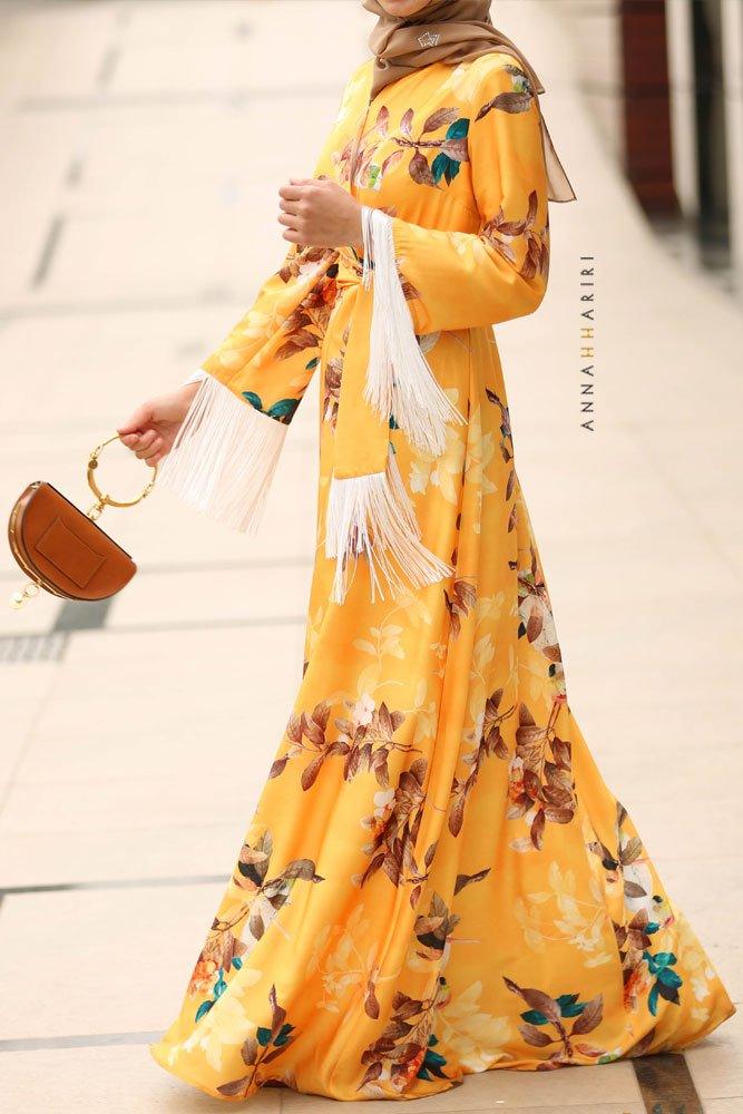 Full body shot of floral satin galabiya dress in mustard color.