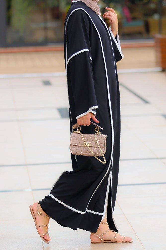 Side view showcasing the sleek design of the Modern Black Abaya with white accents