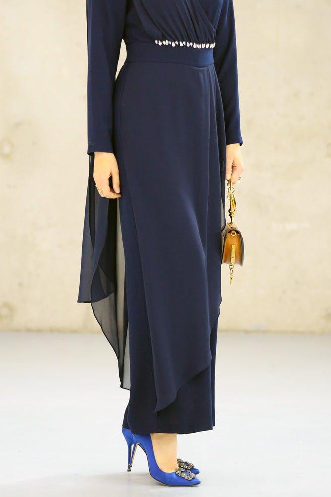 Model walking in navy blue modest jumpsuit
