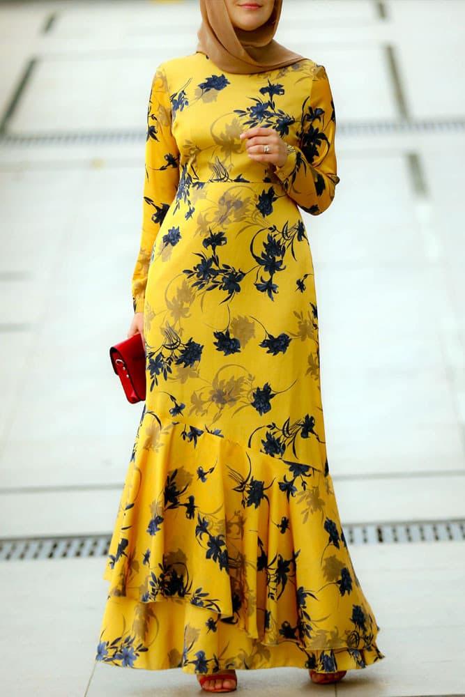 Full body view of the Radiant Yellow Floral Satin Maxi Dress, styled with a hijab